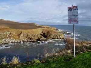 the coastal safety sign on the cliffs at Newtonhill